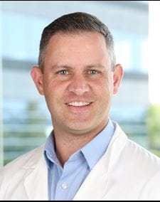 head shot of Dr. Benjamin Rose. Man in lab coat.