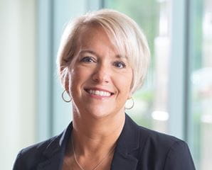 Headhshot of Michele Stokes. Female wearing a black blazer.