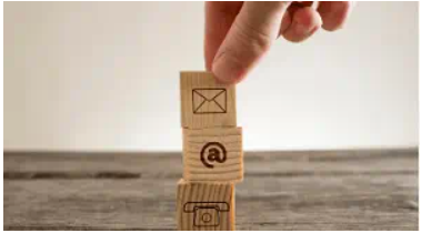 decorative image of different contact icons (email, @ symbol and a telephone)
