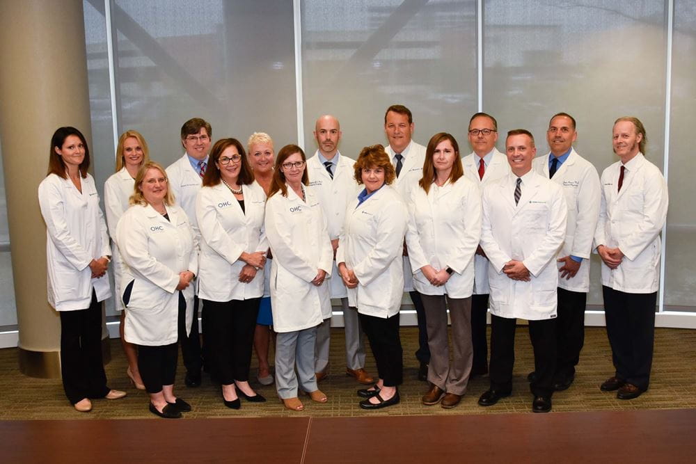 The Jewish Hospital Mercy Health Brain Tumor Center - Tumor Board Group photo of the staff , all wearing white lab coats.